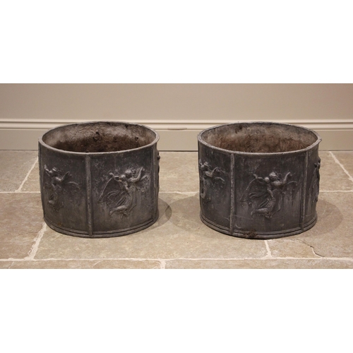 1228 - A pair of cylindrical lead planters, formed with six panels each cast in relief with winged classica... 