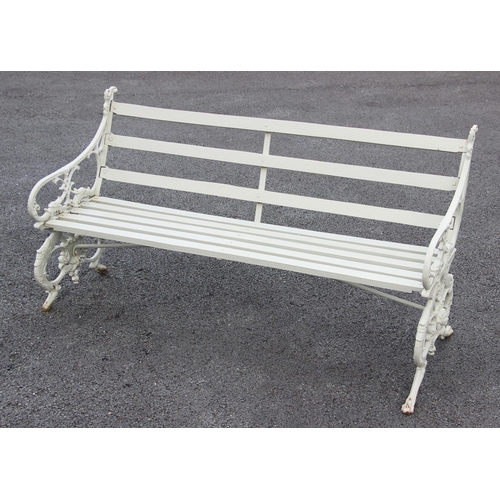 1233 - A Coalbrookdale type painted cast iron and slatted hardwood bench, the bench supports cast as griffi... 