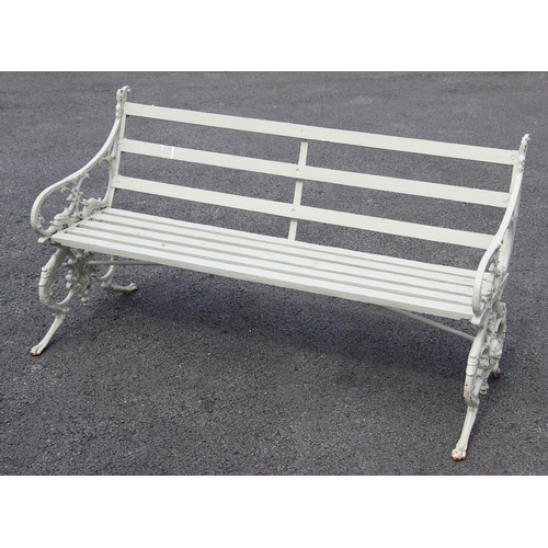 1234 - A Coalbrookdale type painted cast iron and slatted hardwood bench, the bench supports cast as griffi... 