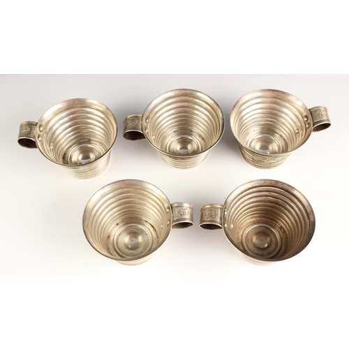 82 - Five silver coloured punch cups, early 20th century, each of tapering ribbed design and with simple ... 