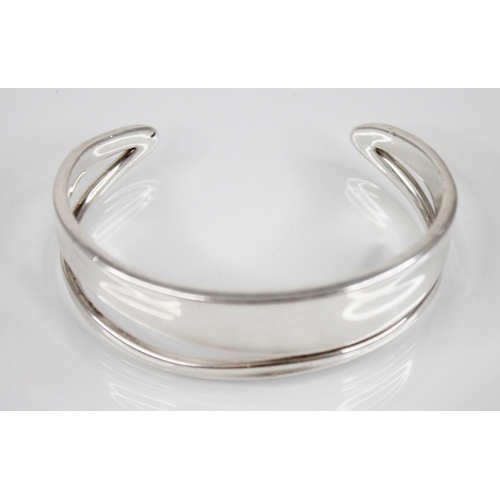 236 - A Georg Jenson 'Marcia' bangle, the openwork stylised bangle of plain polished form, stamped to insi... 