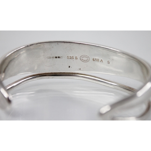 236 - A Georg Jenson 'Marcia' bangle, the openwork stylised bangle of plain polished form, stamped to insi... 