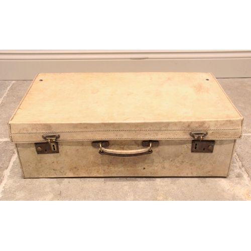 566 - A Finnigans of London vellum travel case, circa 1941, opening to five silver topped jars, comb, shoe... 