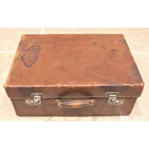 567 - A leather clad ladies travel vanity case, early 20th century, initialled E.A.B, opening to a watered... 