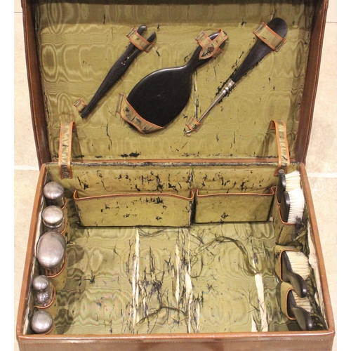 567 - A leather clad ladies travel vanity case, early 20th century, initialled E.A.B, opening to a watered... 