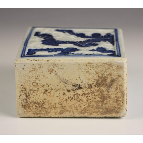 713 - A Chinese porcelain blue and white tea caddy, 18th century, of rectangular form and relief decorated... 