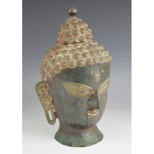 731 - A South East Asian patinated copper head of Buddha, 35cm high