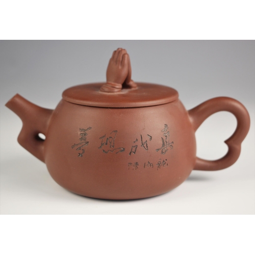 733 - A Chinese Yixing teapot and cover, 20th century, the teapot of compressed circular form with shaped ... 