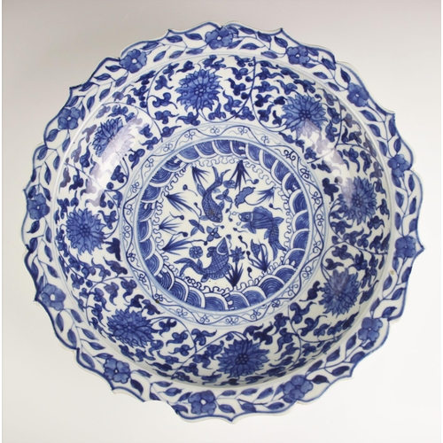 734 - A large Chinese porcelain blue and white bowl, Yongzheng mark but later, of circular form with ogee ... 