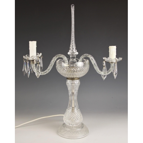 927 - A cut glass table candelabra, 20th century, the pineapple cut baluster column extending to a conform... 