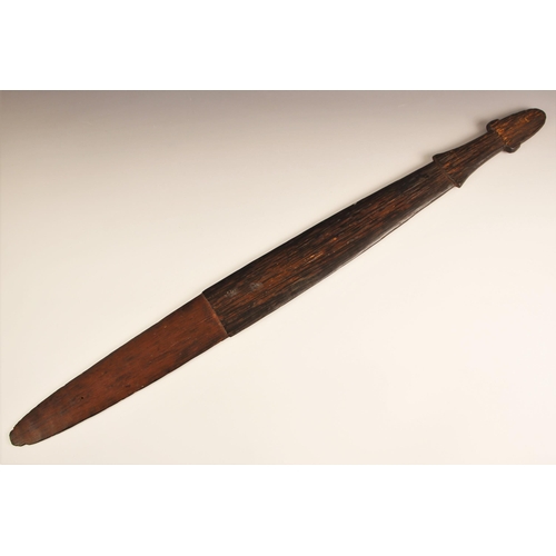 941 - A Papua New Guinea tribal club, 19th/20th century, of paddle form with shaped handle and surface chi... 