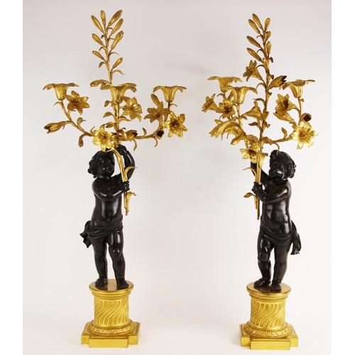 538 - A pair of Napoleon III style bronze and ormolu candelabra after Claude Michel (French, 1738-1814, kn... 