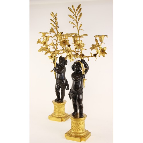 538 - A pair of Napoleon III style bronze and ormolu candelabra after Claude Michel (French, 1738-1814, kn... 