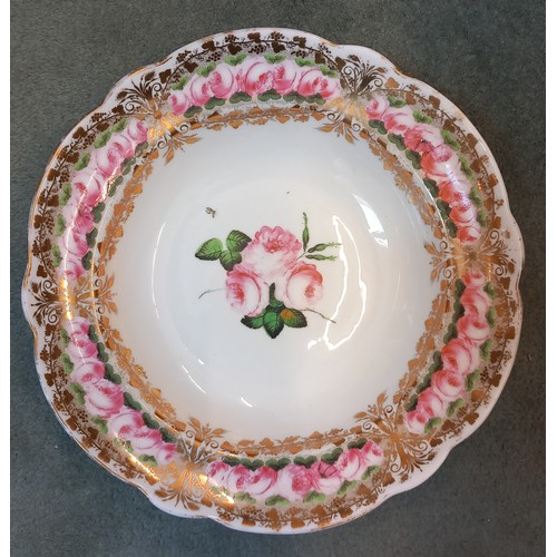 820 - A Welsh Nantgarw porcelain bowl, 19th century, the well with central rose spray, gilt and rose friez... 