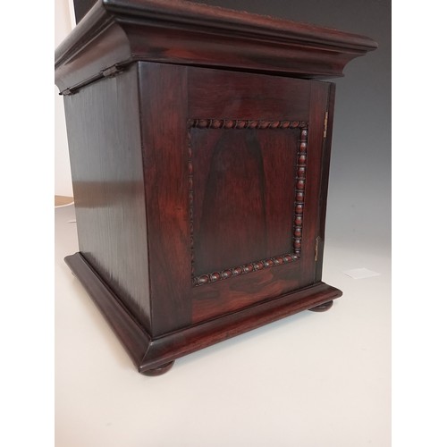 1077 - A William IV rosewood table top work box, the sarcophagus shaped hinged cover applied with moulded b... 