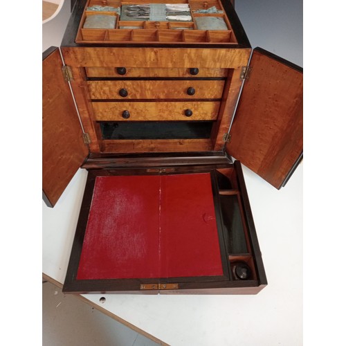 1077 - A William IV rosewood table top work box, the sarcophagus shaped hinged cover applied with moulded b... 