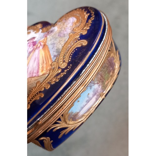 480 - A porcelain enamel Sevres style trinket box, 20th century, of heart shaped form, with a central scen... 