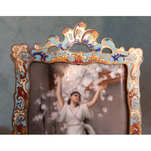 794 - A French porcelain plaque, late 19th century, depicting a classical maiden beneath a prunus tree, wi... 