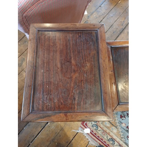 1210 - A nest of three Chinese rosewood tables, 20th century, of rectangular form, with a carved vinery ope... 