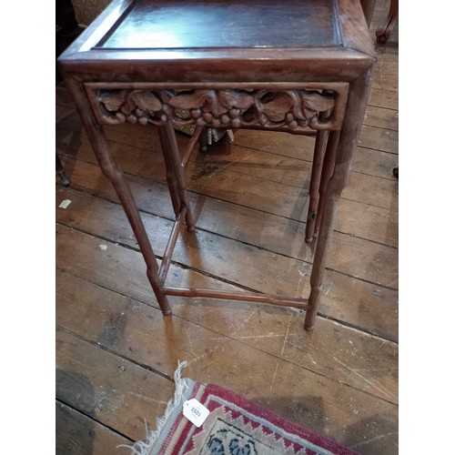 1210 - A nest of three Chinese rosewood tables, 20th century, of rectangular form, with a carved vinery ope... 