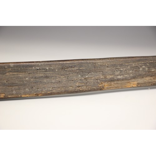 935 - A Papua New Guinea palm wood paddle club, 123cm long, with a Papua New Guinea palm wood bow with bam... 