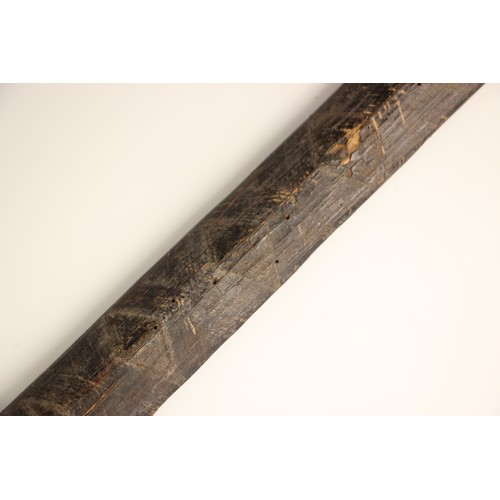 935 - A Papua New Guinea palm wood paddle club, 123cm long, with a Papua New Guinea palm wood bow with bam... 