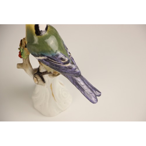 807 - A Meissen porcelain model of a Great Tit, 19th century, perched upon a branch with gilt highlights, ... 