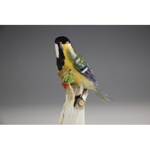 807 - A Meissen porcelain model of a Great Tit, 19th century, perched upon a branch with gilt highlights, ... 