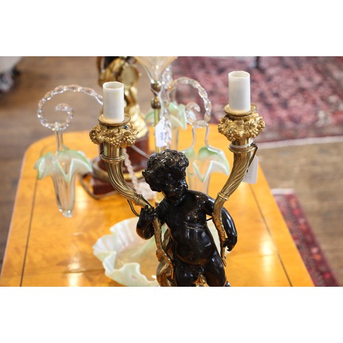 925 - A pair of French bronze and ormolu figural table lamps, 20th century, each modelled as a patinated b... 