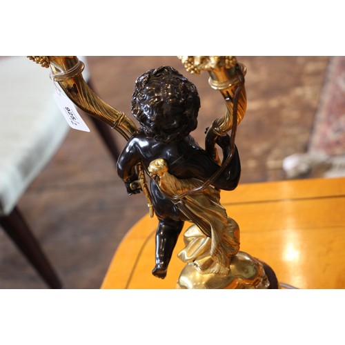 925 - A pair of French bronze and ormolu figural table lamps, 20th century, each modelled as a patinated b... 