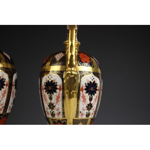 846 - A pair of Royal Crown Derby Imari urns, pattern number 1128, each of ovoid form with high scroll han... 