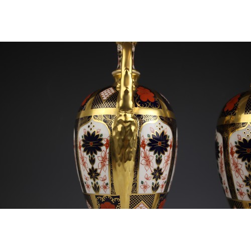 846 - A pair of Royal Crown Derby Imari urns, pattern number 1128, each of ovoid form with high scroll han... 