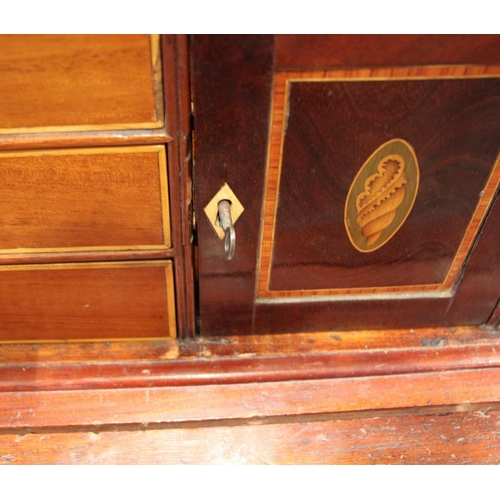 1002 - A continental walnut, mahogany and marquetry secretaire abattant, early 19th century, the dentil cor... 