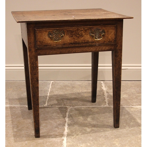 1026 - A George III oak side table of cottage proportions, the over-sailing plank top above a single oak li... 