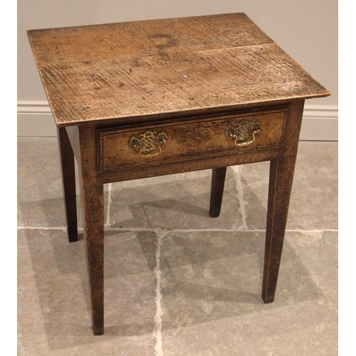 1026 - A George III oak side table of cottage proportions, the over-sailing plank top above a single oak li... 