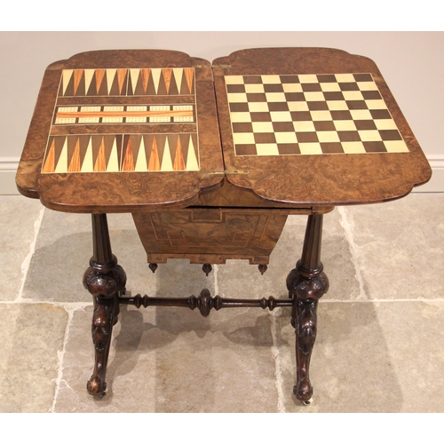 1062 - A Victorian burr walnut games/work table, the quarter veneered and marquetry inlaid hinged top, open... 