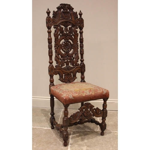 1069 - A carved walnut Carolean style hall chair, 19th century, the carved foliate and 'C' scroll high back... 