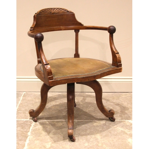 1072 - A walnut revolving office/desk chair, by Maple & Co, late 19th/early 20th century, with a demi lune ... 