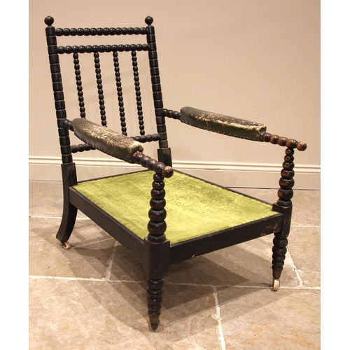 1073 - An ebonised bobbin turned open armchair, possibly walnut, mid to late 19th century, with bespoke but... 