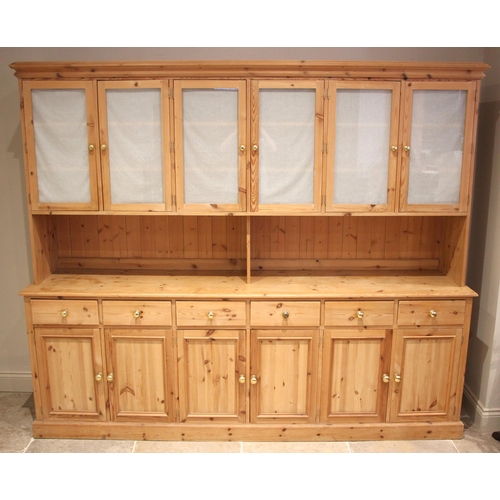 1082 - A large Victorian style pine dresser/housekeepers cupboard, late 20th century, the moulded cornice o... 