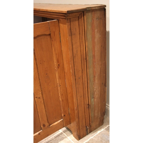 1085 - A large Victorian pitch pine ecclesiastical hall cupboard, formed with two pairs of panelled cupboar... 