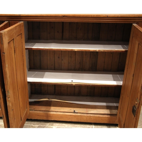 1085 - A large Victorian pitch pine ecclesiastical hall cupboard, formed with two pairs of panelled cupboar... 