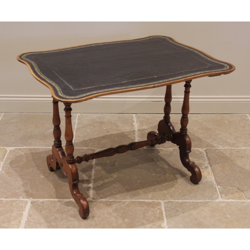 1088 - A 19th century mahogany writing table, the serpentine shaped top inset with a gilt tooled skiver, up... 