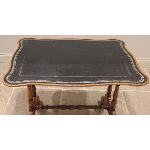 1088 - A 19th century mahogany writing table, the serpentine shaped top inset with a gilt tooled skiver, up... 