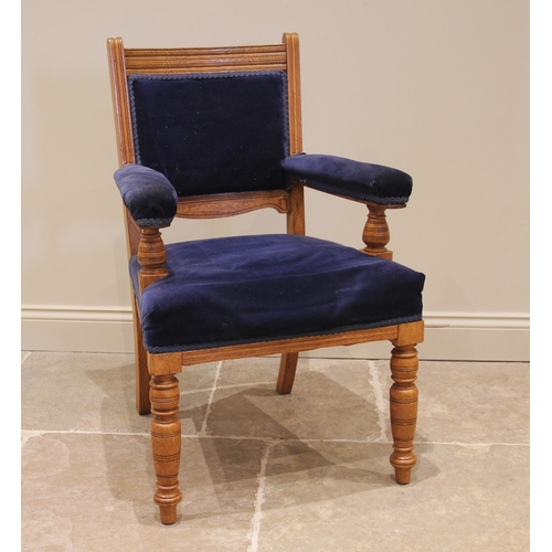 1090 - A Victorian golden oak and upholstered library/elbow chair, later re-covered in blue velour, the pad... 