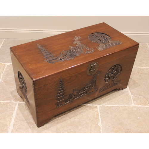 1095 - A Chinese camphor wood blanket chest, mid 20th century, the hinged cover carved in deep relief with ... 