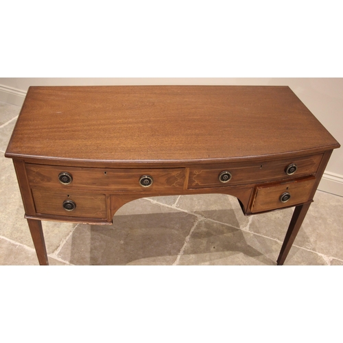 1105 - An Edwardian mahogany bowfront dressing table/desk, formed as an arrangement of four small drawers, ... 