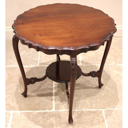 1106 - An Edwardian mahogany occasional table, the shaped top with a moulded edge, upon slender leaf moulde... 