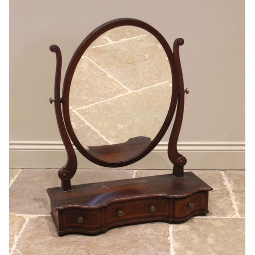 1113 - An Edwardian mahogany dressing table mirror, the oval mirror upon curved supports and a shaped plint... 