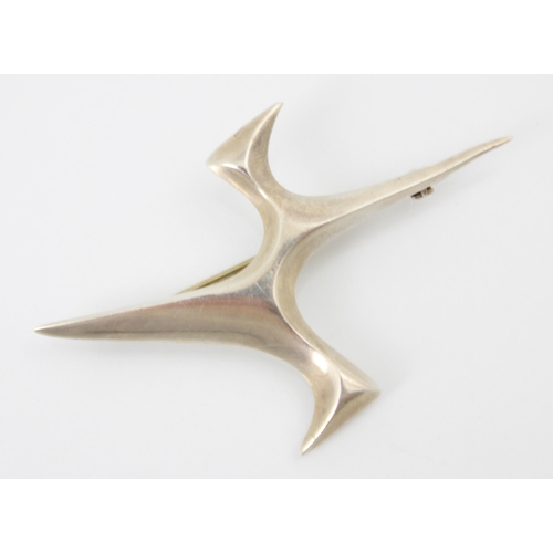 163 - A 1970's Ivan Tarratt 'Flight' brooch designed by Ernest A Blyth, the plain polished brooch of abstr... 